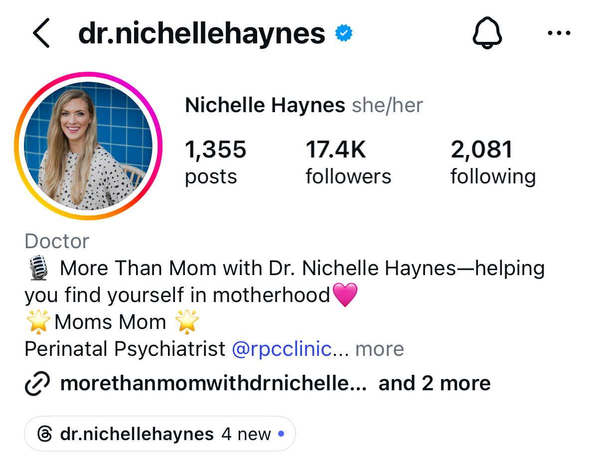 Profile picture of a woman with long blonde hair, smiling, against a blue background, wearing a patterned top.