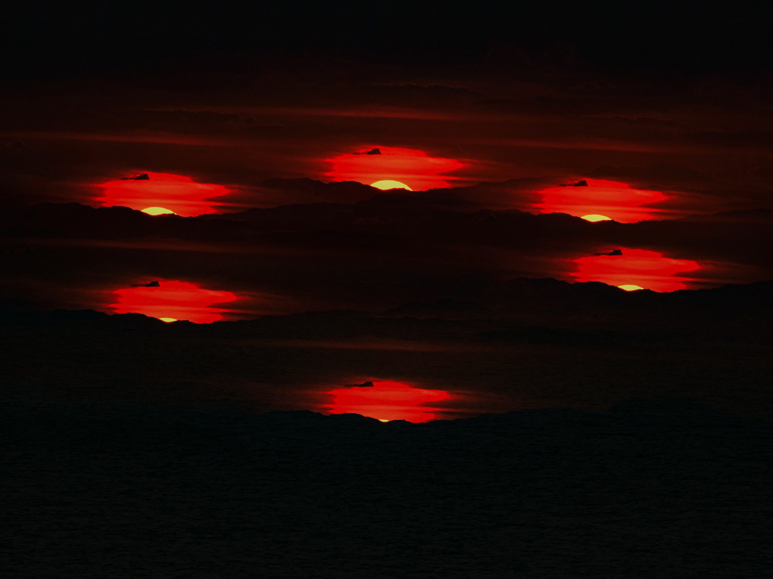 Multiple red and orange sunset or sunrise views with dark clouds and sky, layered horizontally across the image.