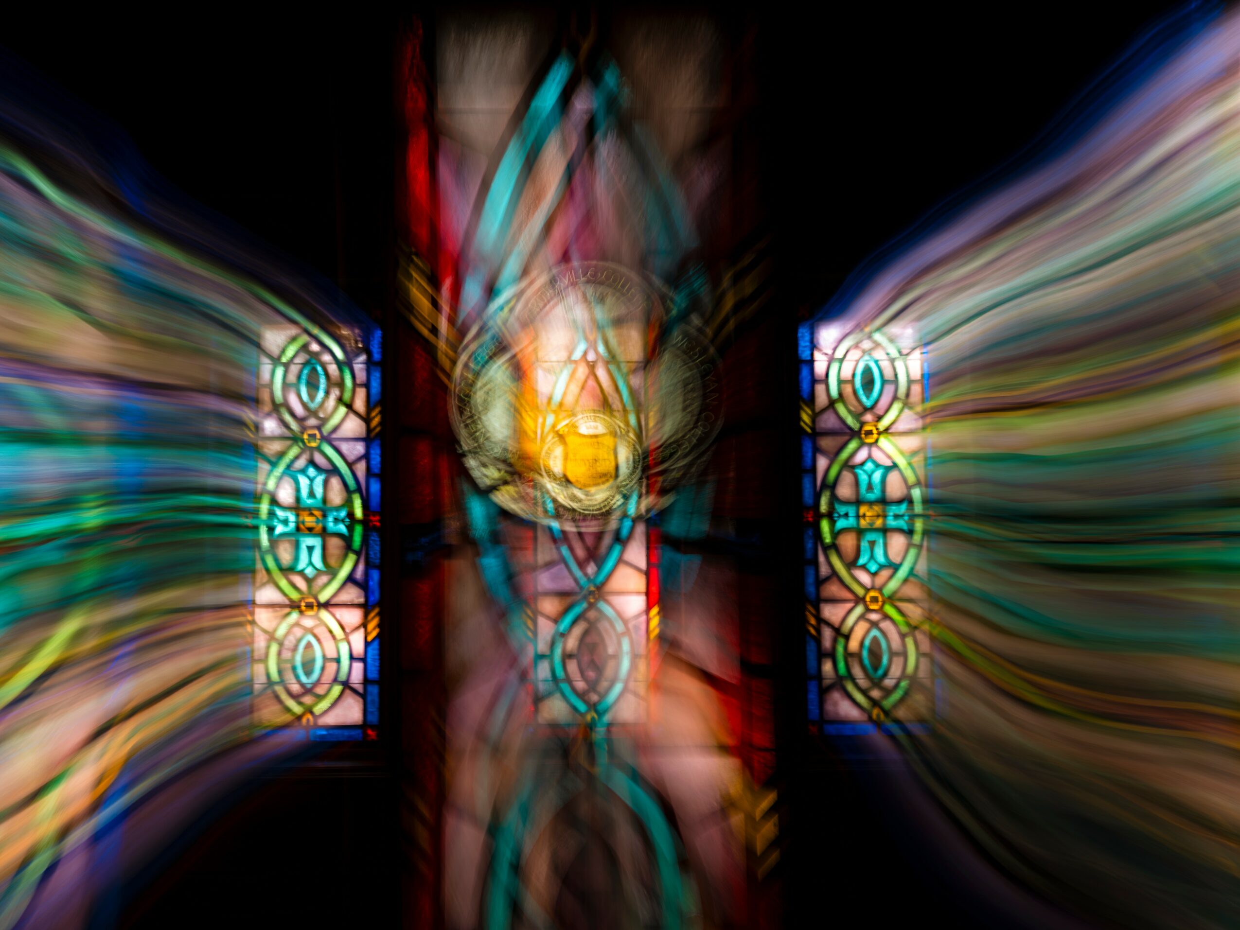 Colorful, abstract stained glass windows with light reflections and symmetrical patterns, creating a vibrant, glowing scene.