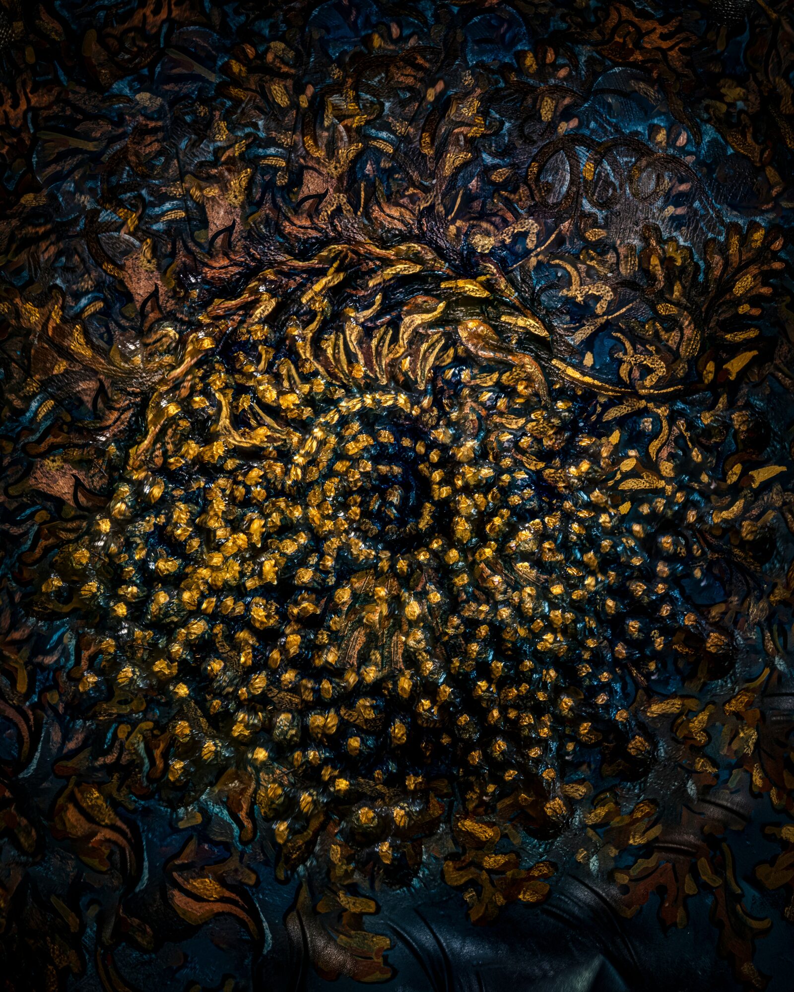 Close-up of a spiral pattern with yellow and dark brown elements, resembling a textured, abstract design.