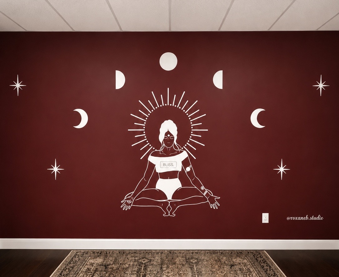 Wall mural of a meditating figure with a halo, moon phases, and stars on a red background.