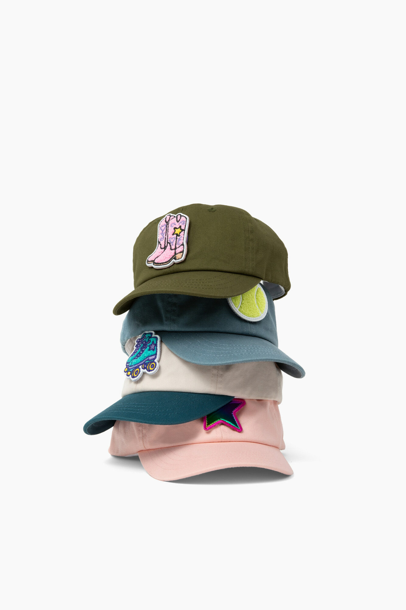 Stack of four colorful baseball caps with embroidered patches, on a white background.