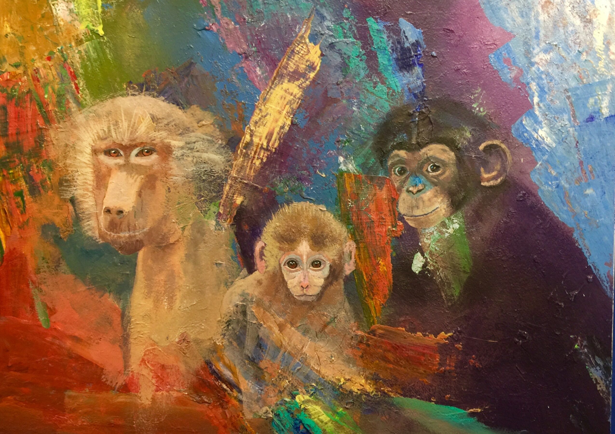 Three monkeys in front of a colorful abstract background, with one large, one medium, and one small monkey, all looking forward.