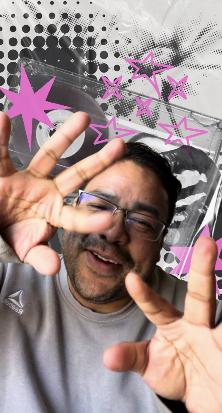 Man with glasses smiling and making peace signs with both hands, background with pink star graphics and black dots.