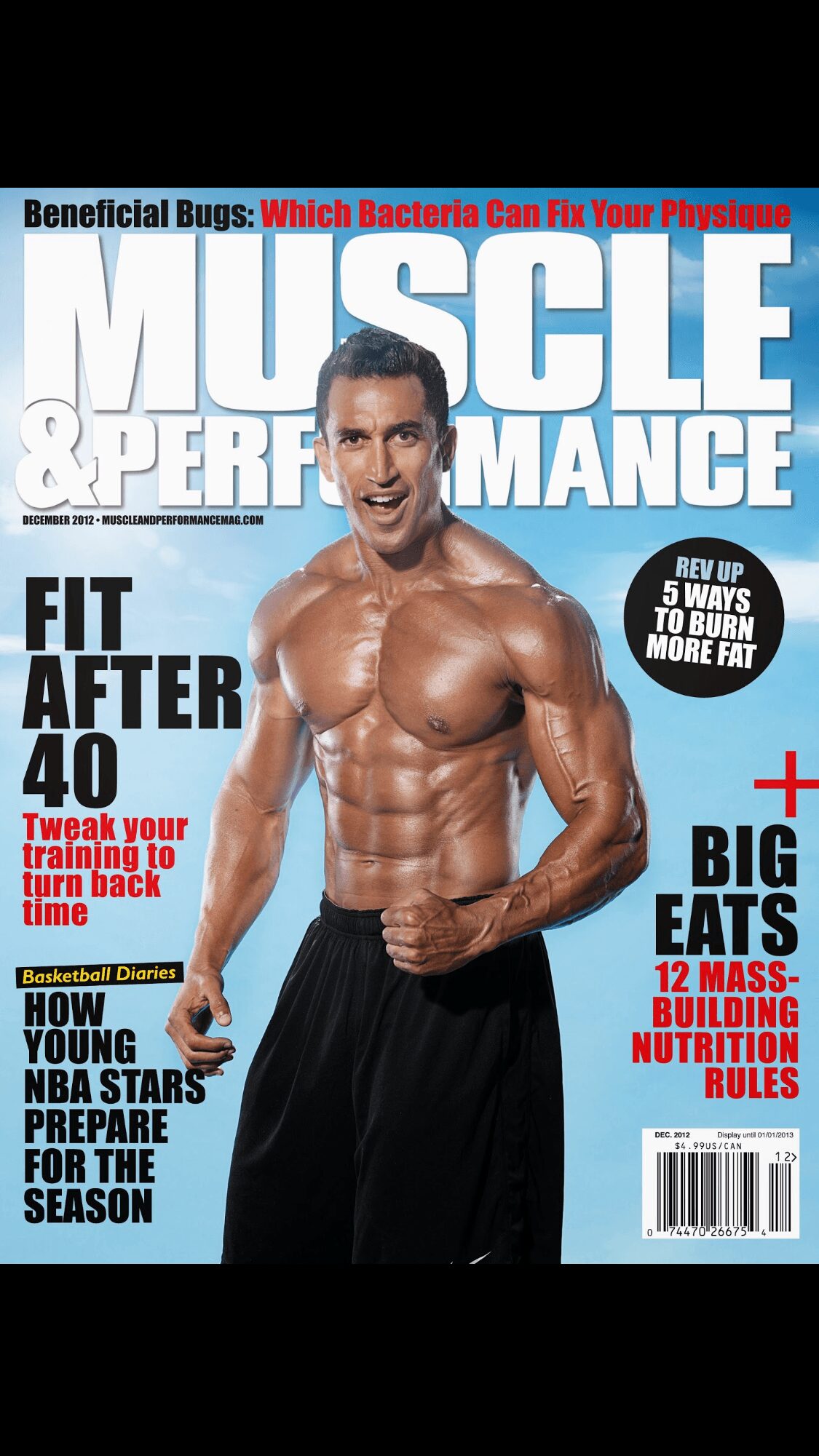 Man with muscular physique smiling, wearing black pants, magazine cover background with text and headlines.
