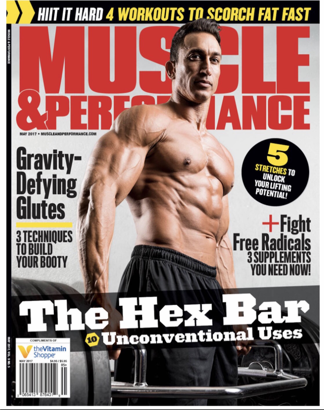 Muscular man with defined abs and arms, shirtless, standing in a gym setting, magazine cover with bold text and headlines.