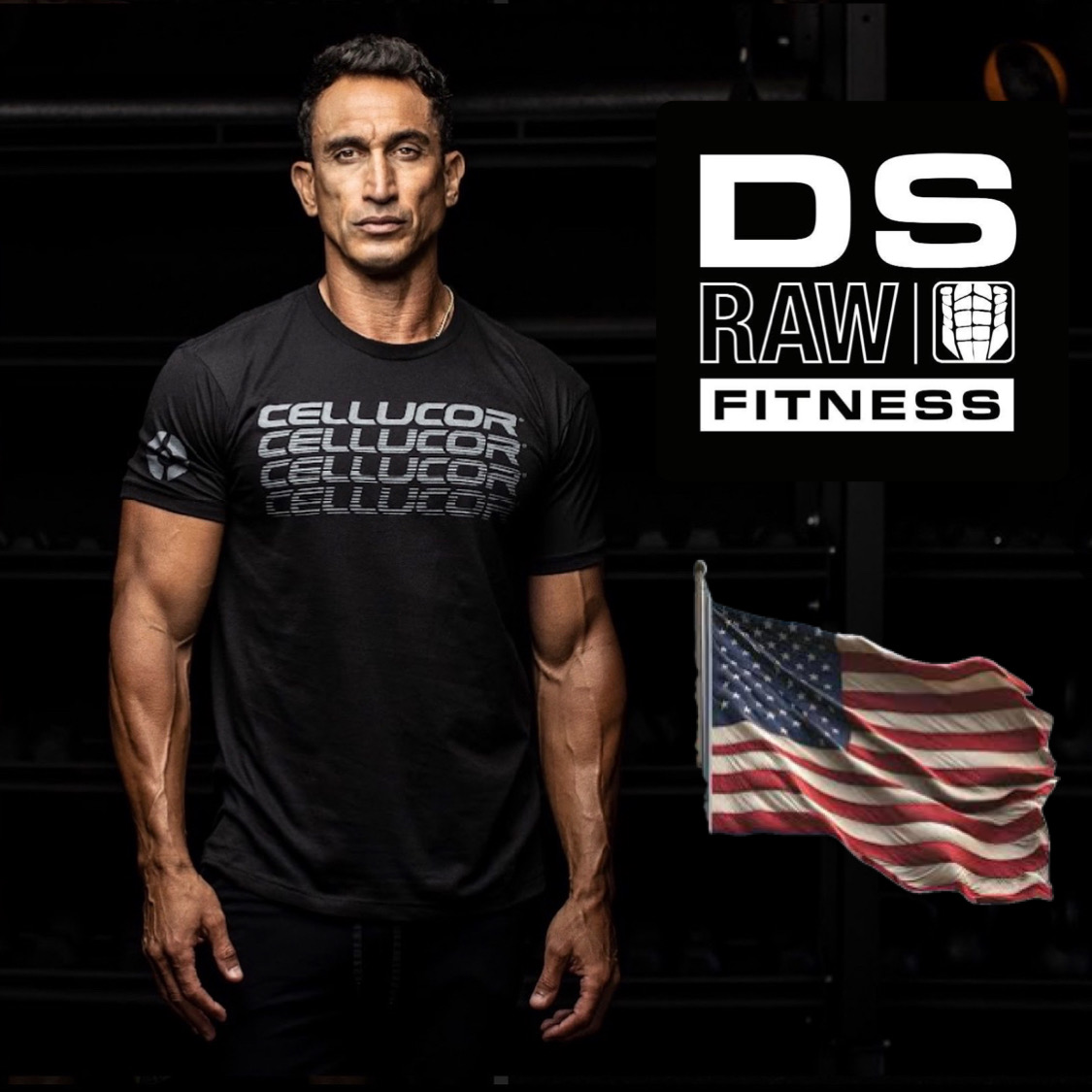 Man standing in front of a black background with a flag and fitness logo, wearing a black T-shirt, looking at the camera.
