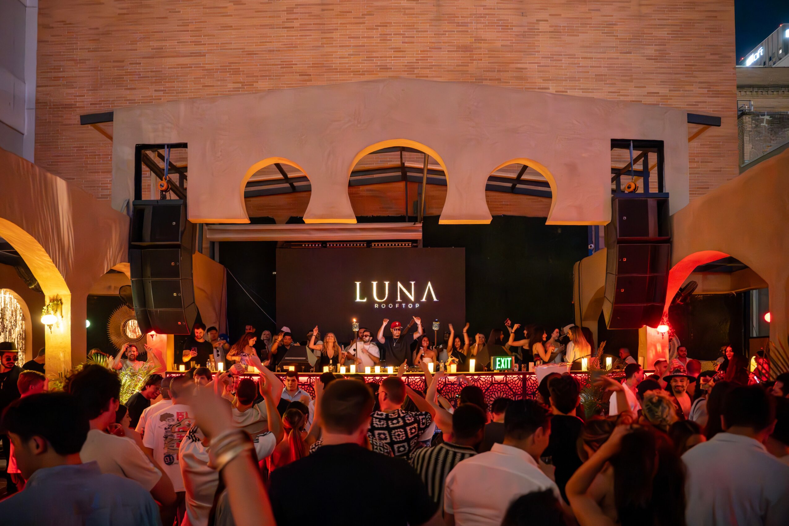 Crowd watching a live music performance on stage with a large screen displaying 'LUNA' in the background.