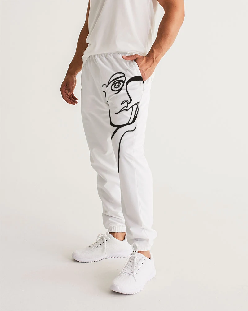 Person wearing white pants with a black line drawing of a face on the left leg, white shoes, and a white top.