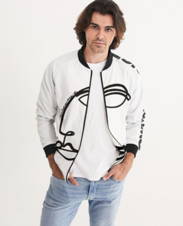 Young man with shoulder-length hair wearing a white jacket with black accents and a graphic design, standing against a white background.