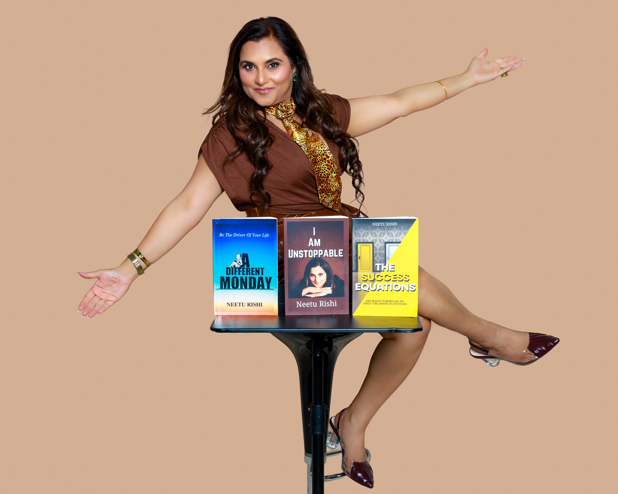 Woman balancing on a table with three books, arms extended, against a beige background.