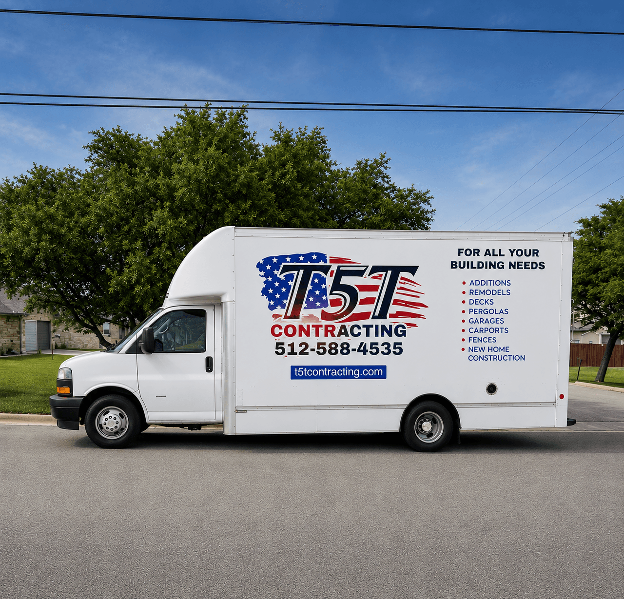 White contracting truck with logo and contact info parked on street, trees and blue sky in background.