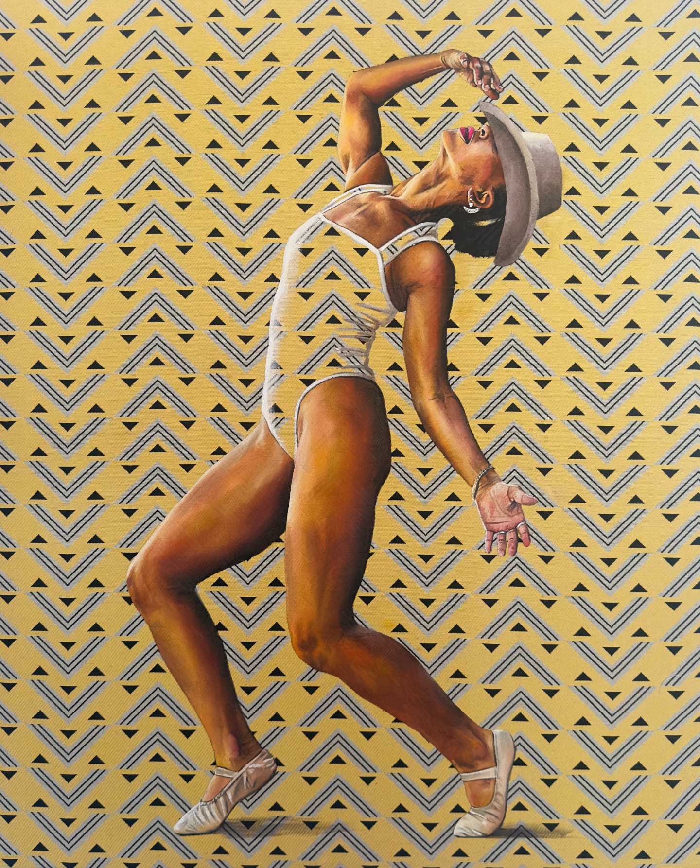 Person in a hat and swimsuit poses with one arm raised, against a patterned background.