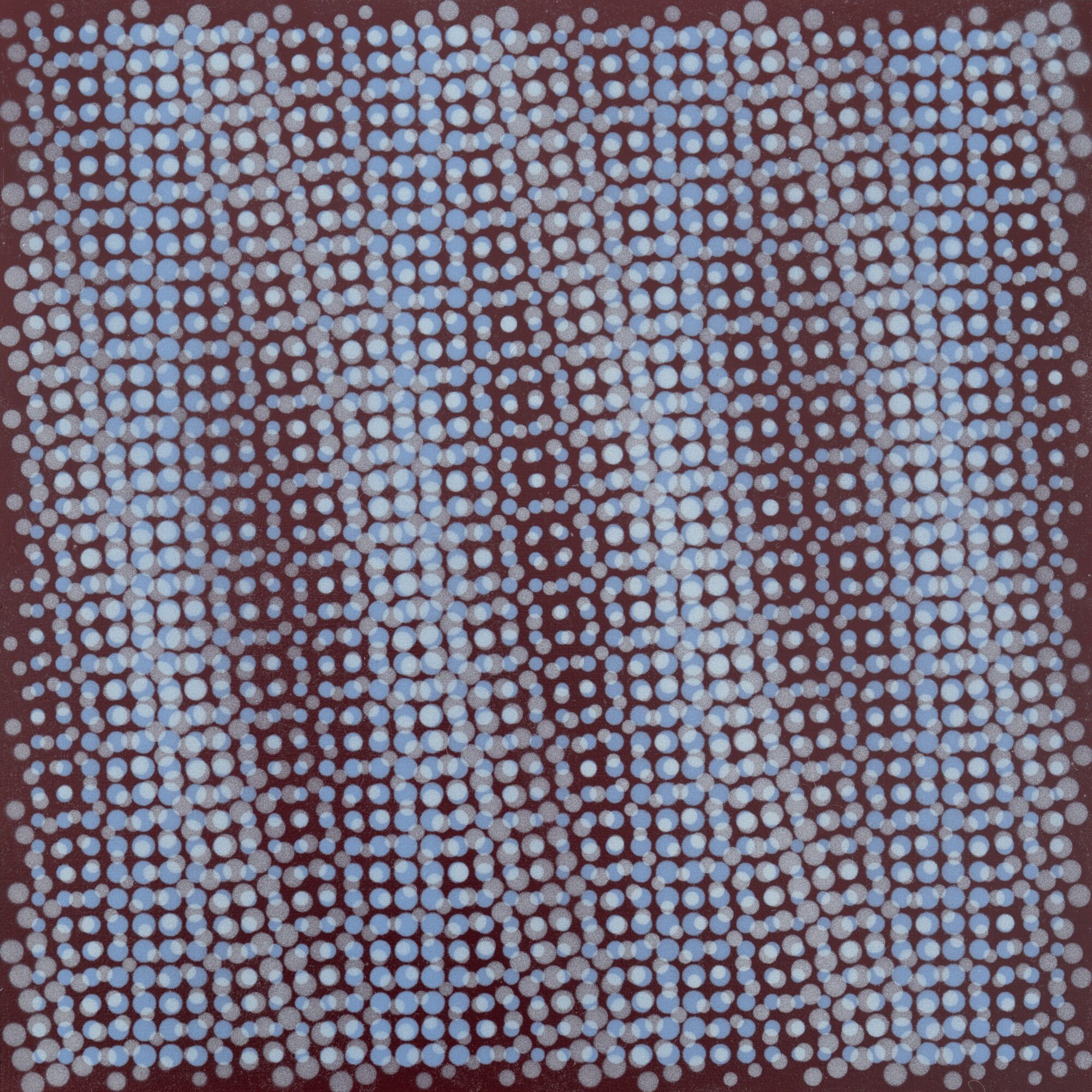 Abstract pattern of small blue and brown dots arranged in a grid-like formation.