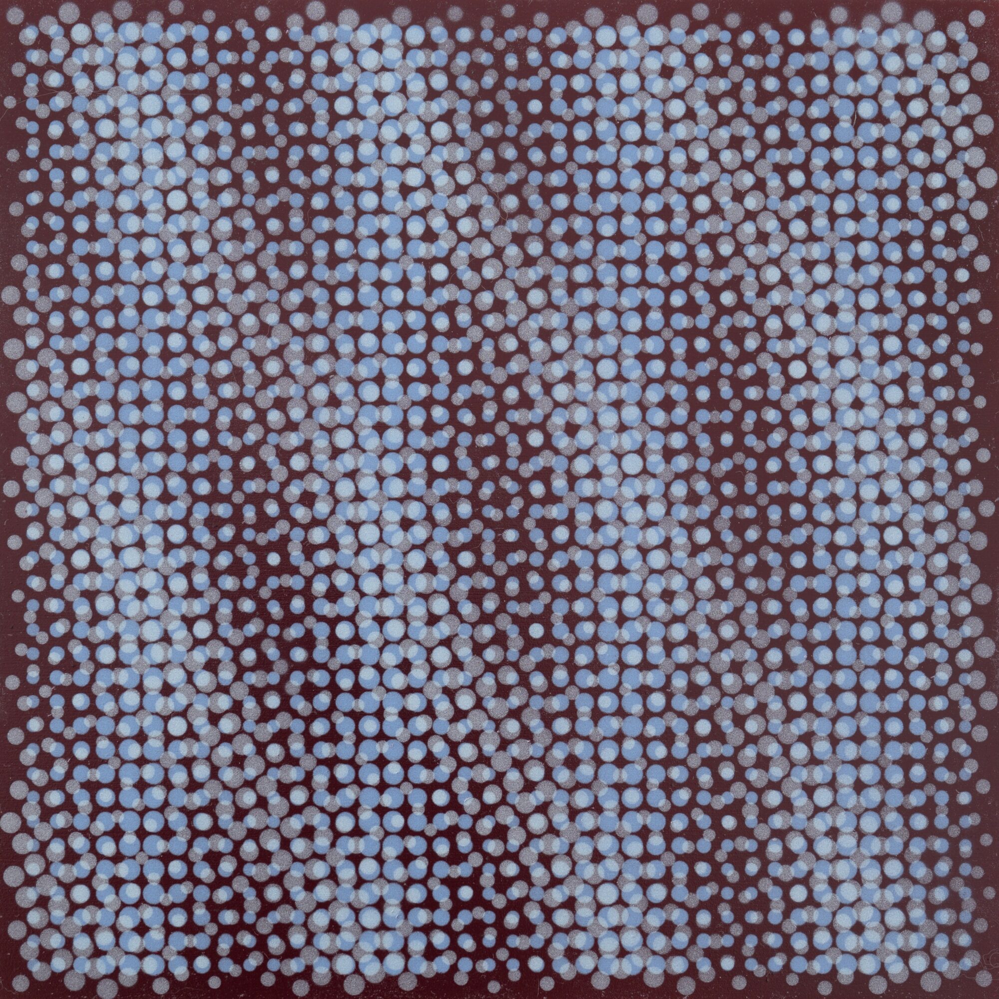 A pattern of small, light blue dots arranged in a grid on a dark background.