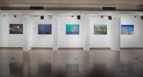 Gallery with six colorful paintings on white walls, polished floor, and ceiling lights.