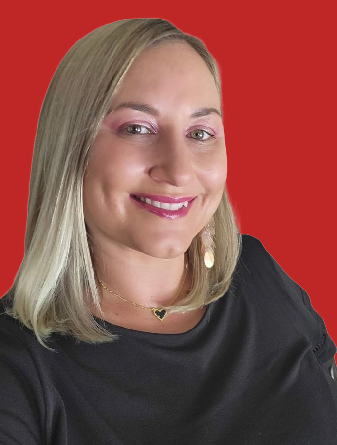 Portrait of a woman with blonde hair smiling, wearing a black top and gold jewelry, against a red background.